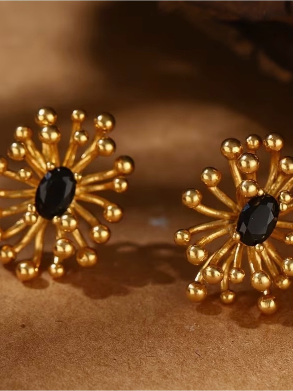 Gold Floral Burst Stud Earrings with Black Stone